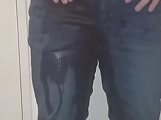 Lad boy pissing his trousers and caressing