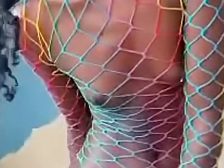 Skinny black riding dildo in a rainbow colored fishnet