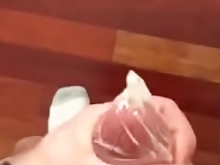 Cumming in a condom at one's fingertips home while everyone is not present