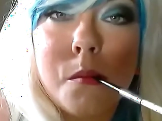 A Ash-blonde Tina Snua Smoking 2 Slender Cigarettes In A Holder