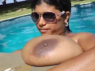 Dark-skinned Plumper called Krissy masturbates away from the pool